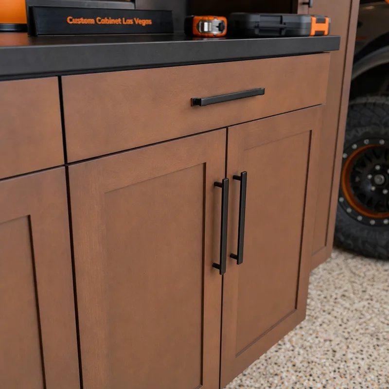 Close-up of aligned garage cabinet doors and drawers, handle hardware, and a durable finished surface
